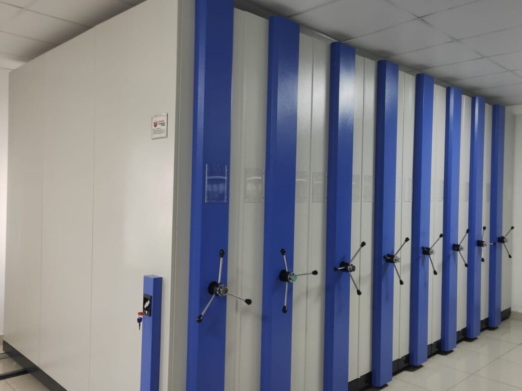 mobile compactor storage system with high density metal shelving for organized warehouse storage