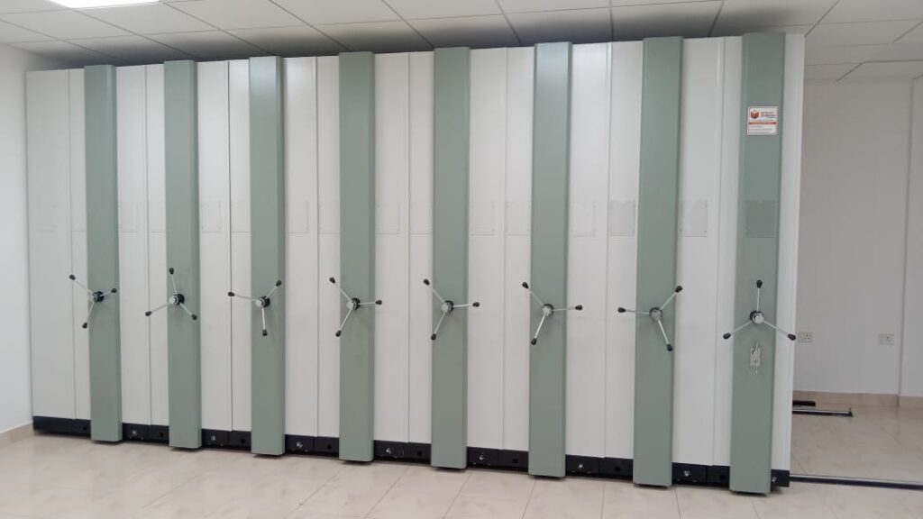 High density mobile compactor storage system with manual drive mechanism installed in storage room