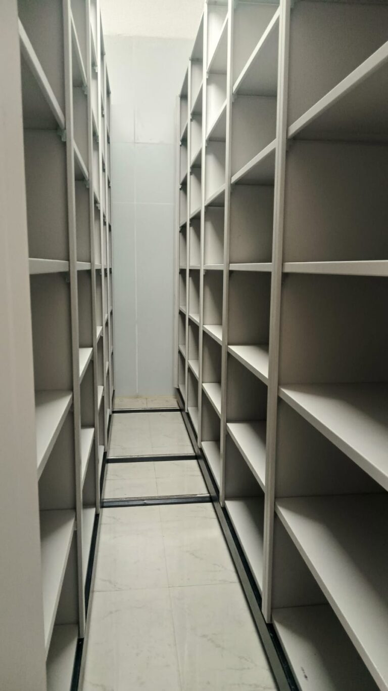 Case Study 22 Interior view of 5 bay mechanical file compactor showing multi-level shelving on both sides with floor-mounted rail tracks installed at Gulbrandsen Technologies GIDC Jhagadia Bharuch Gujarat by Myriad Storage System